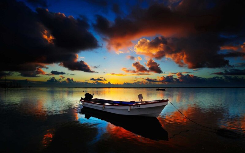Small Boat at Sunset — Blue, Dramatic, Photograph, Clouds, Water