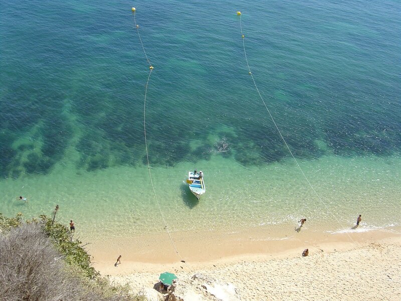 Small Boat in Clear Water — Blue, Serene, Afternoon, Photograph, Beach