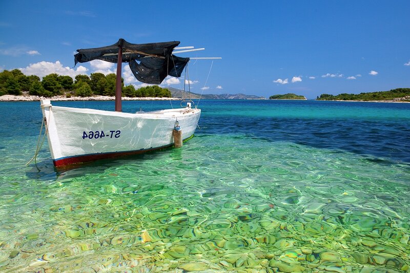 Small Boat in Clear Water — Blue
