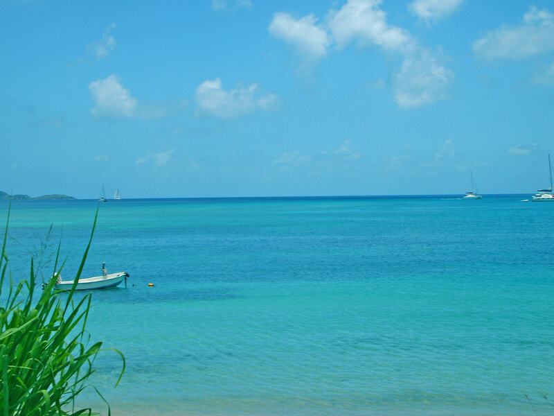Small Boat in Turquoise Water — Blue