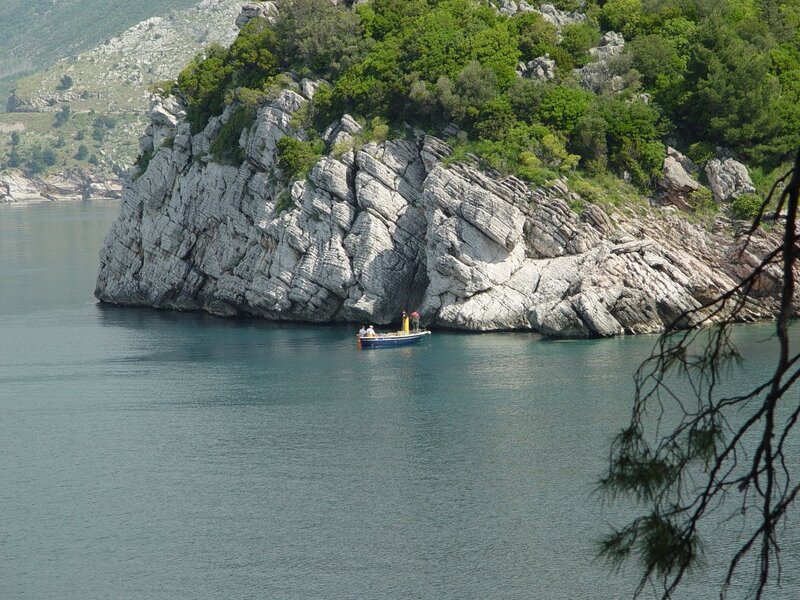 Small Boat Near Cliff — Blue