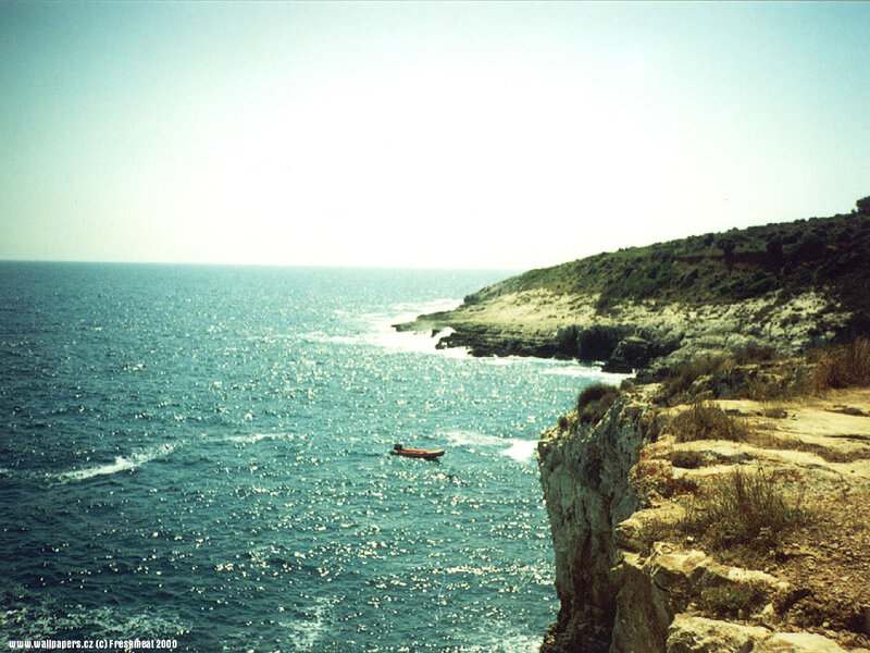 Small Boat Near Cliff