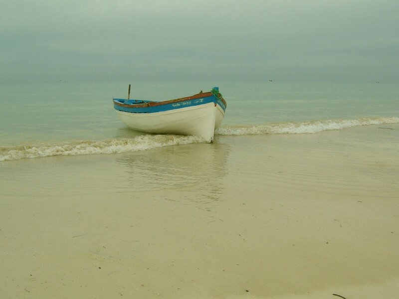 small boat on a quiet beach