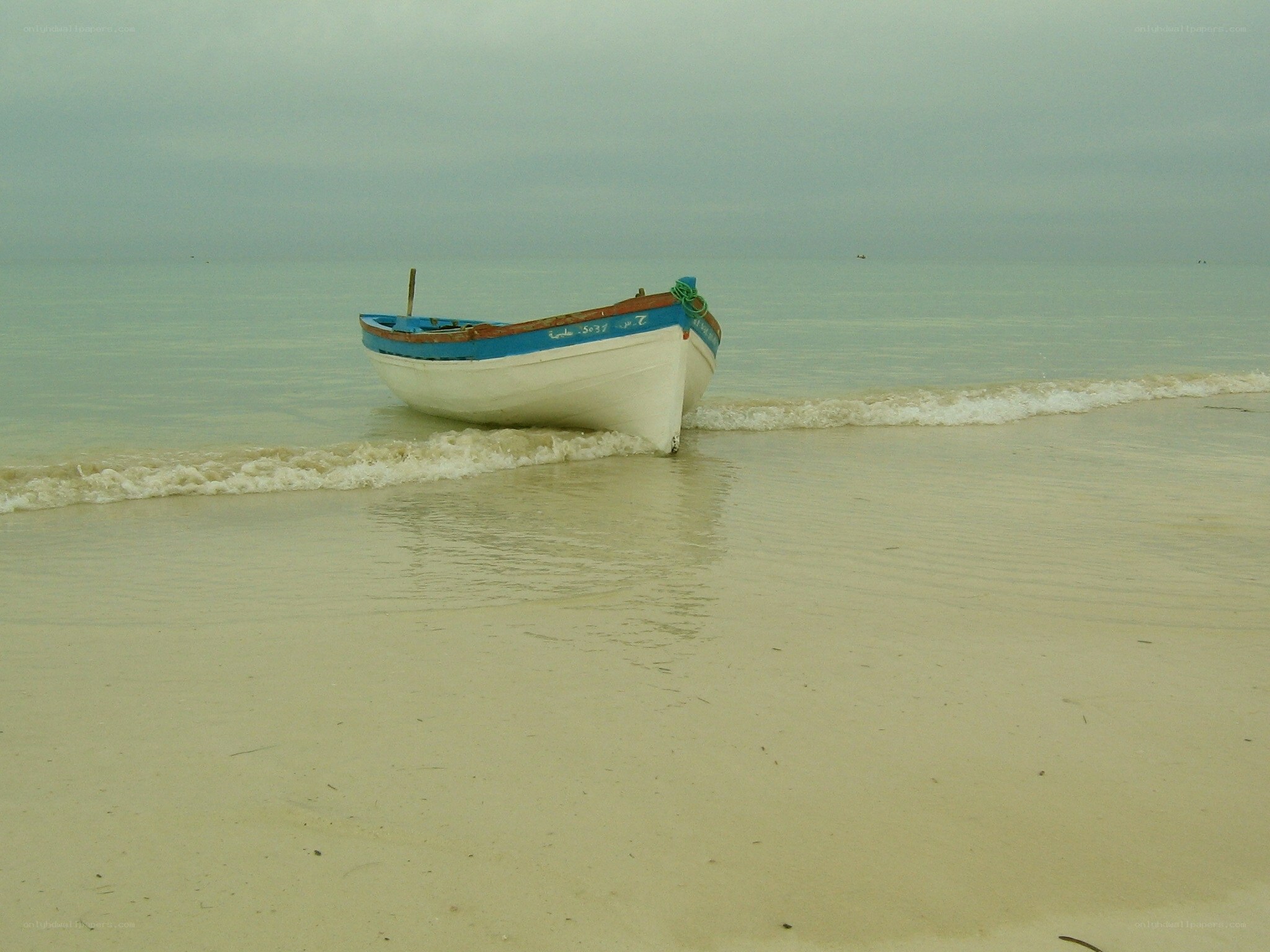 small boat on a quiet beach