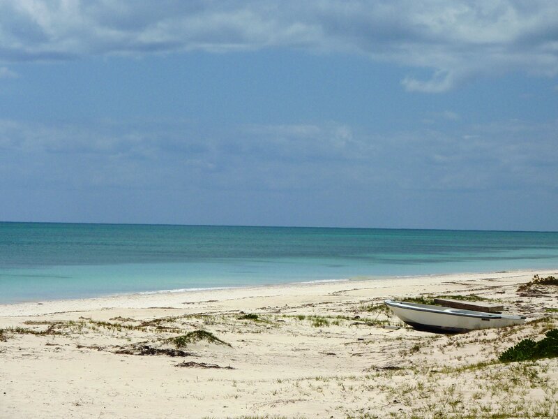 Small Boat on Beach — Blue, Serene, Afternoon, Photograph, Sand, Ocean