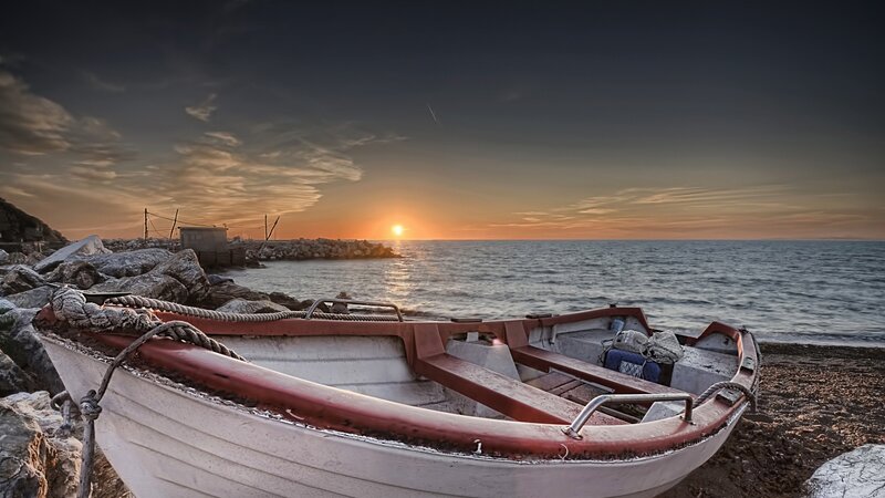 Small Boat on Beach — Orange, Serene, Sunset, Photograph, Rocks