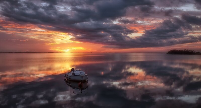 Small Boat on Calm Water — Orange, Dramatic
