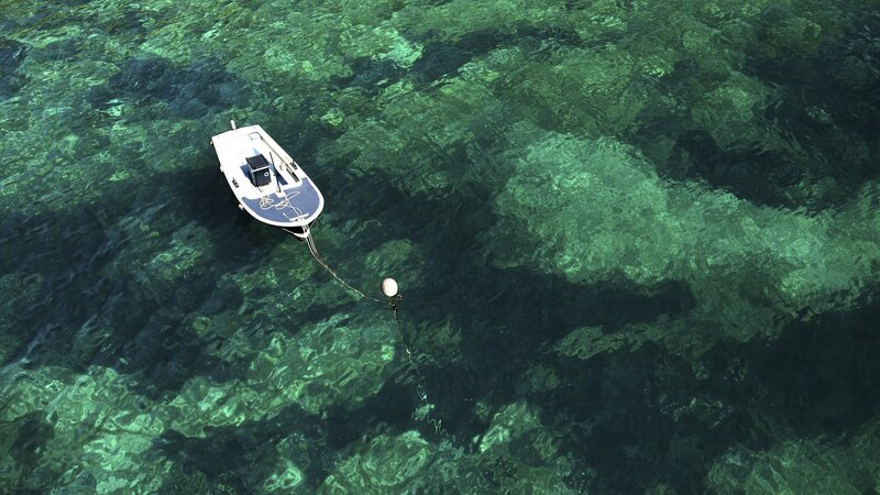 Small boat on clear water