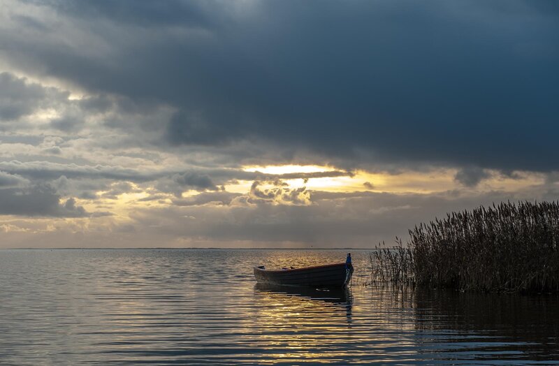 Small Boat on Lake — Blue, Dramatic, Sunset, Photograph