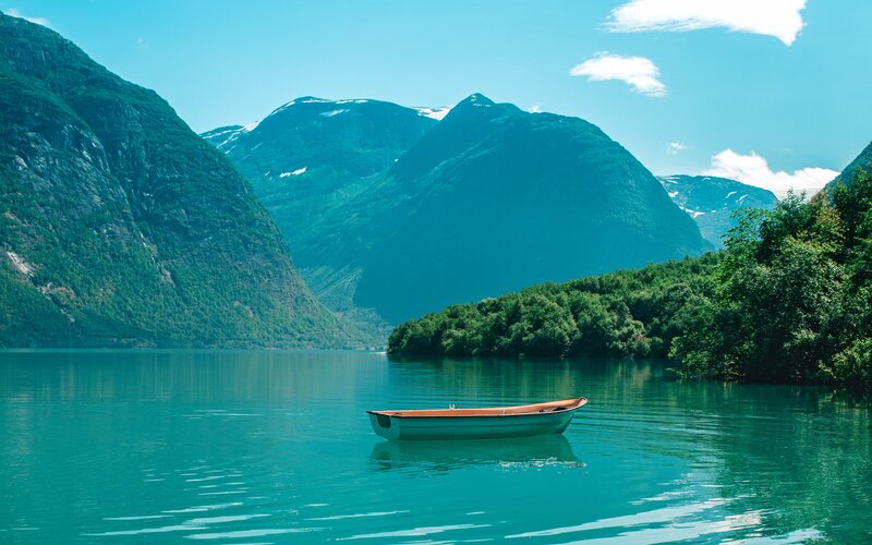 Small Boat on Lake — Blue, Serene, Afternoon, Photograph, Mountains, Trees, Sky