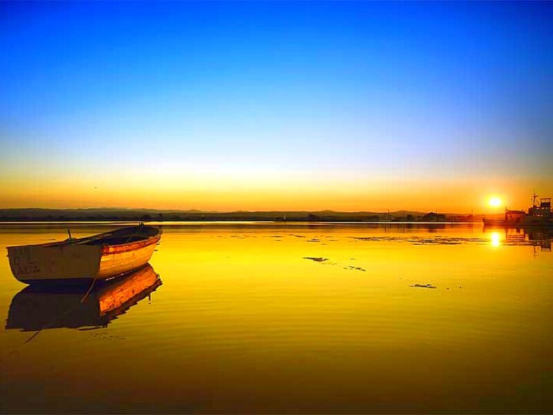 Small Boat on Lake — Blue, Serene, Sunset, Photograph, Sun, Reflection