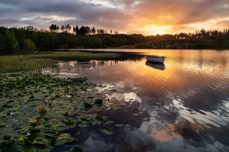 Small Boat on Lake — Orange, Serene, Sunset, Photograph, Lily Pads