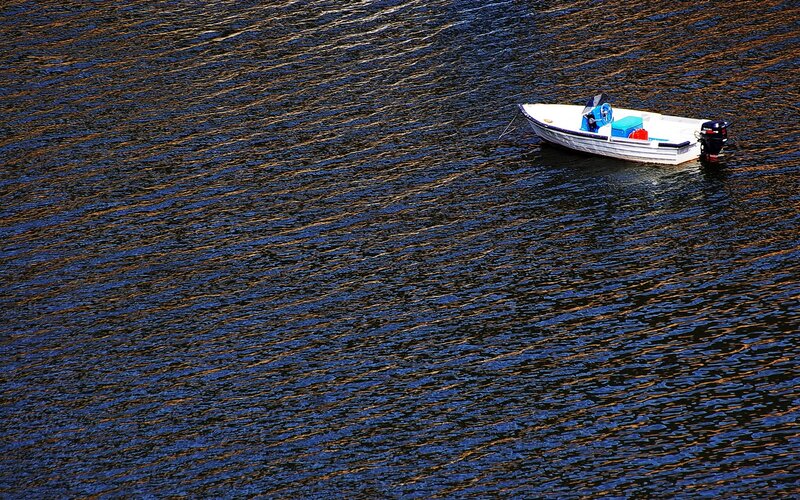 Small boat on rippling water