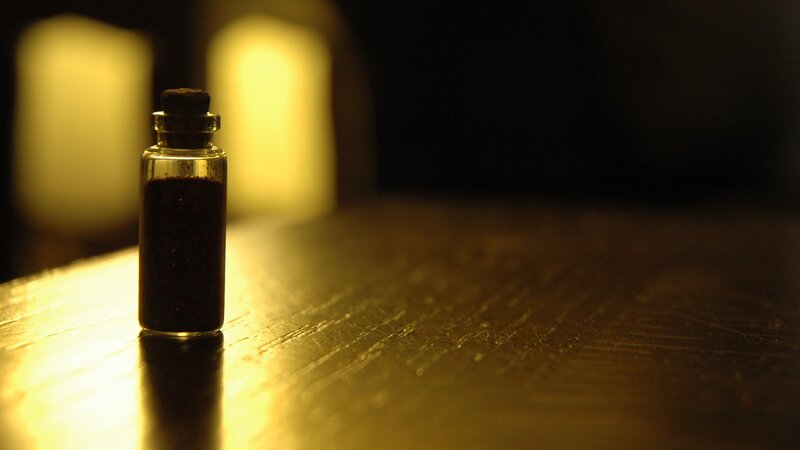 small bottle with dark liquid
