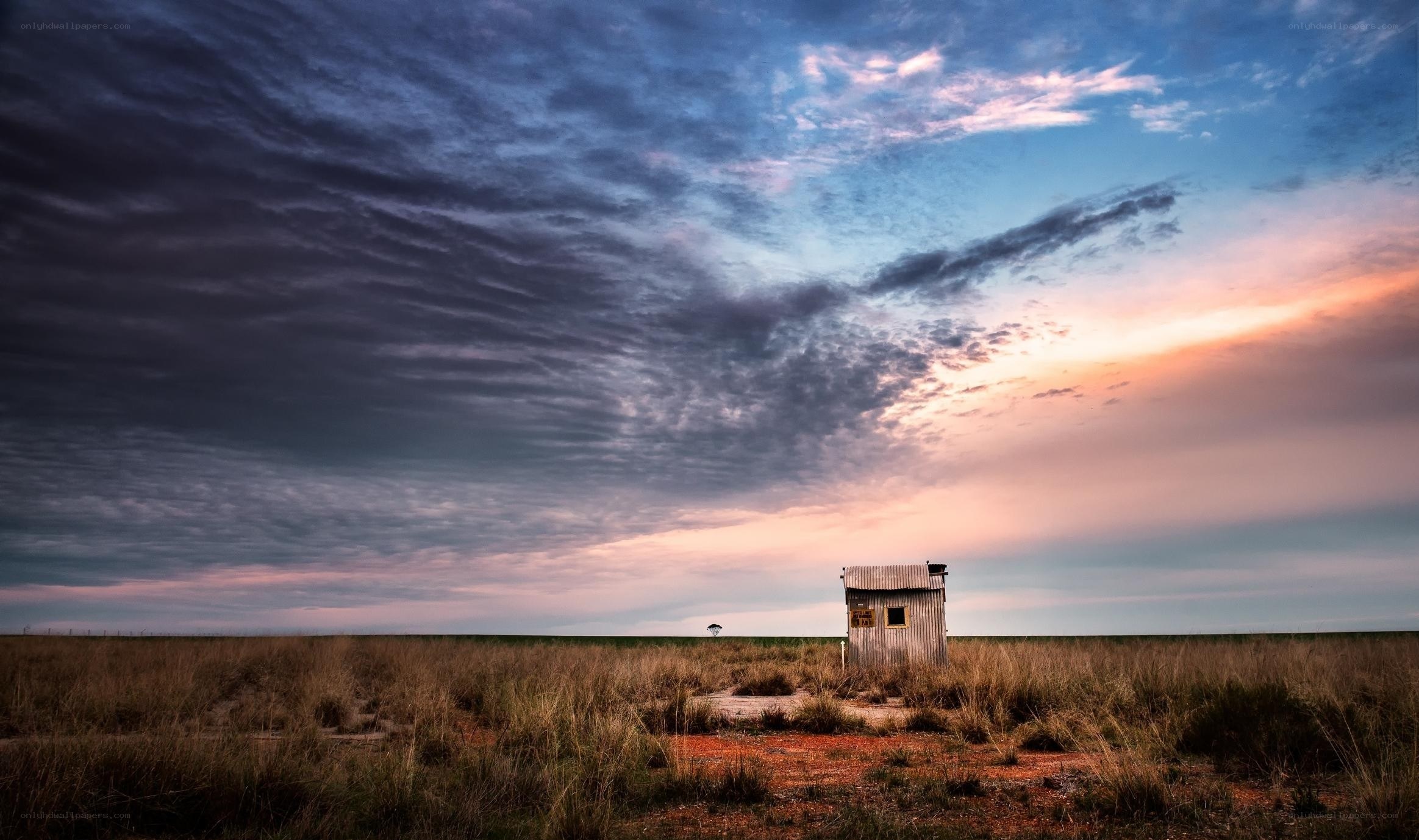 Small hut in a vast field