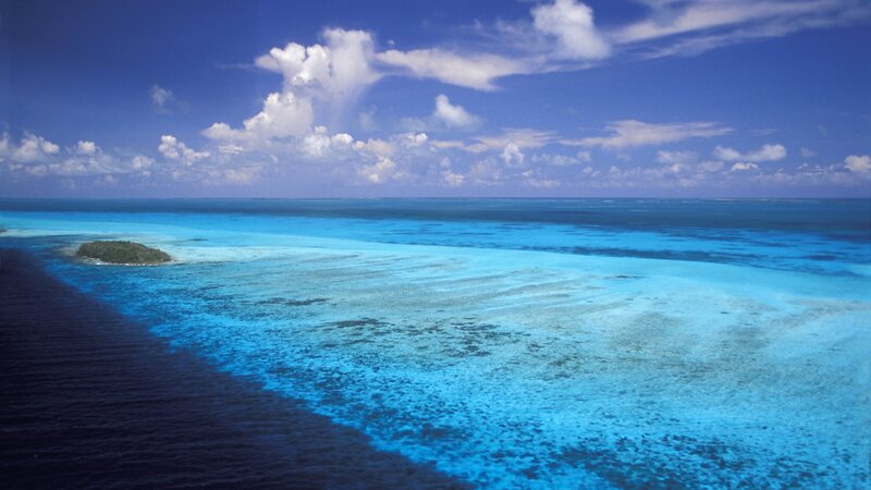 Small Island in Ocean — Blue, Serene, Afternoon, Photograph, Sky, Clouds, White