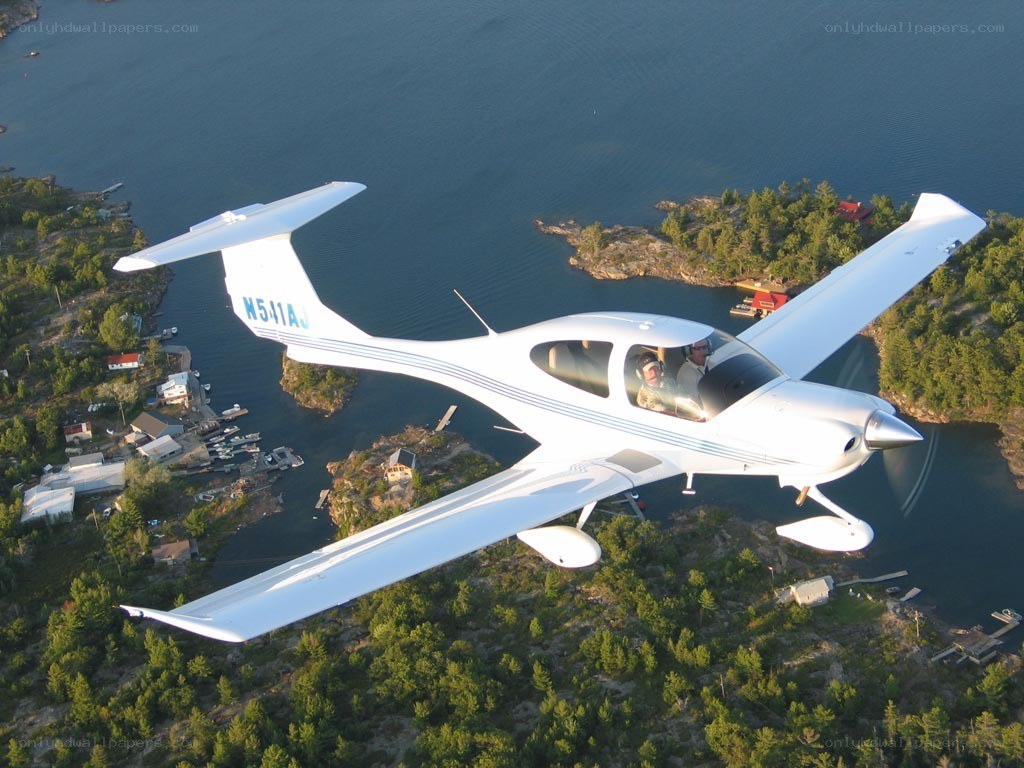 small plane flying over lake