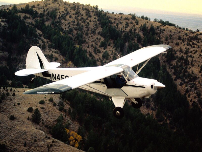 small plane flying over mountains