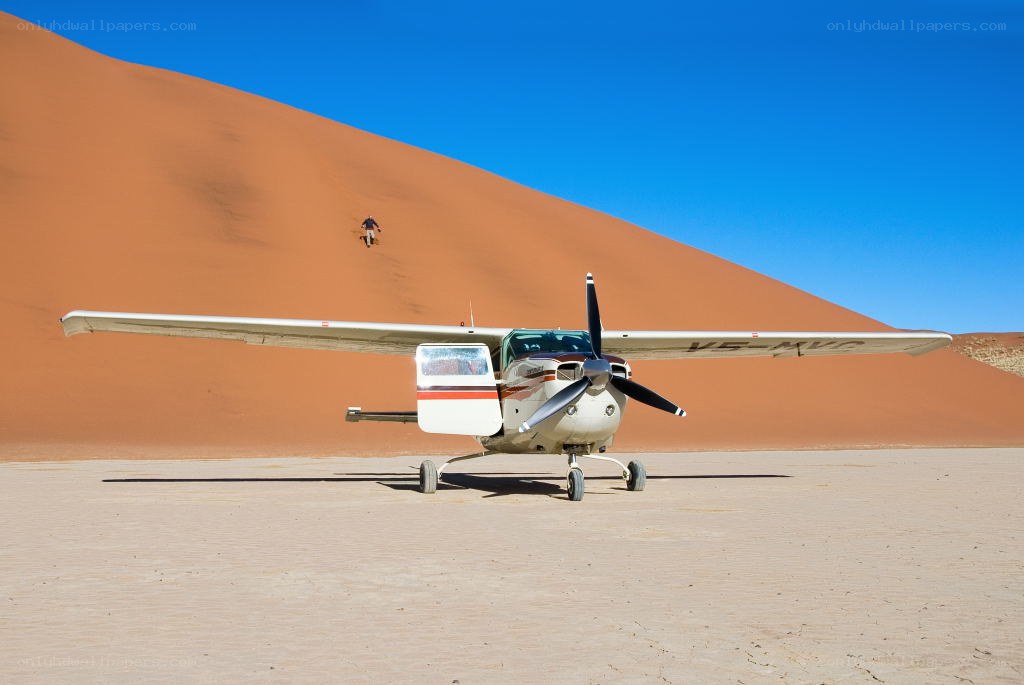 Small plane on desert dune