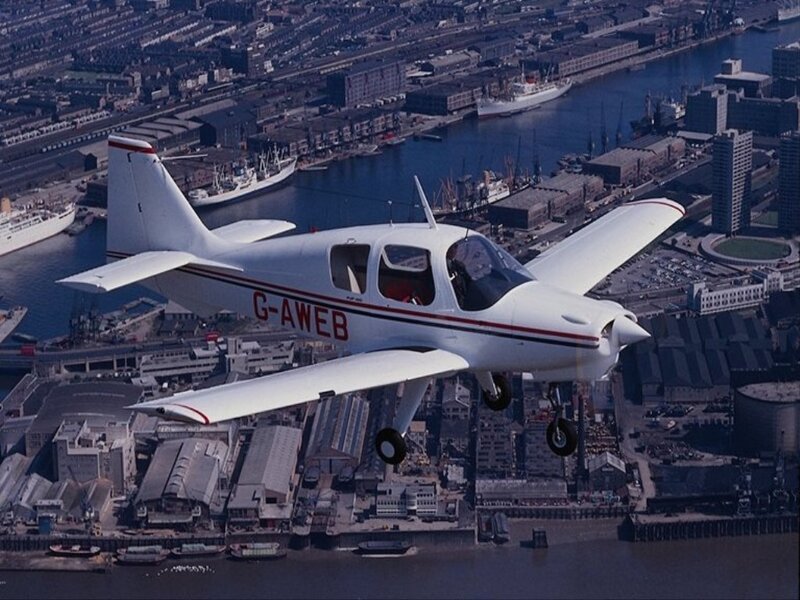 Small plane over city harbor