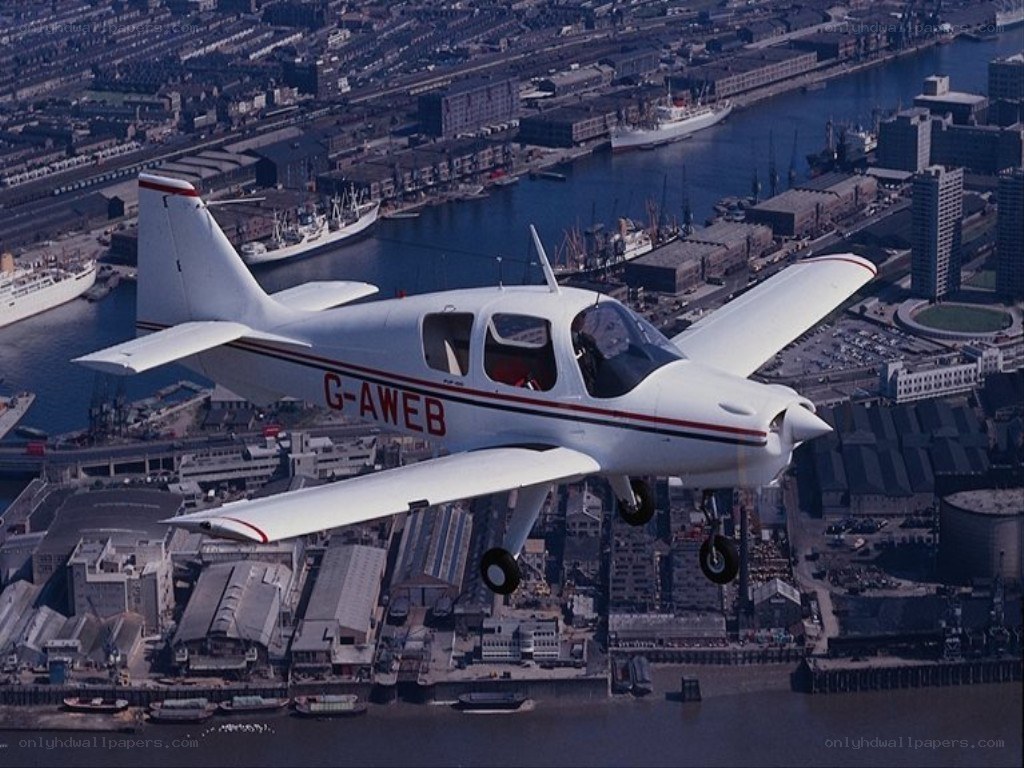 Small plane over city harbor
