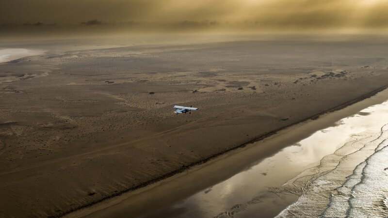 Small Plane over Desert — Brown