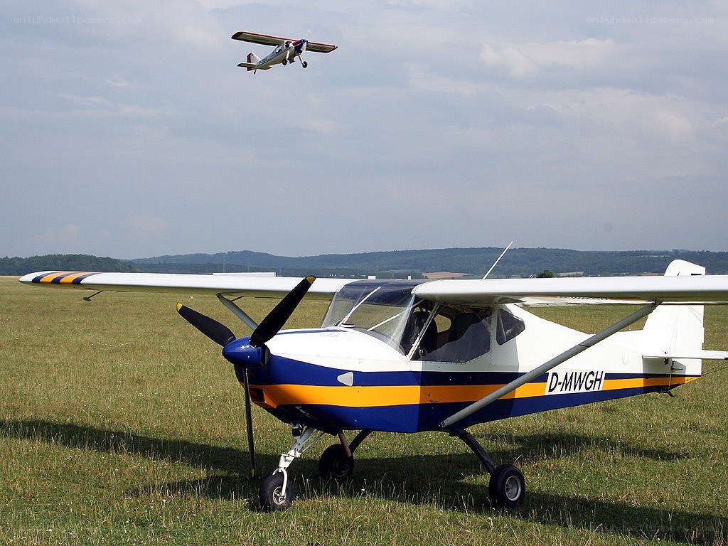 Small planes on a grass airfield