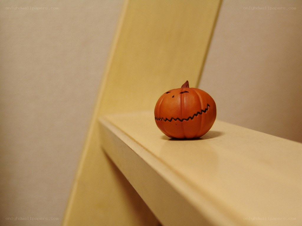 Small pumpkin figurine on shelf