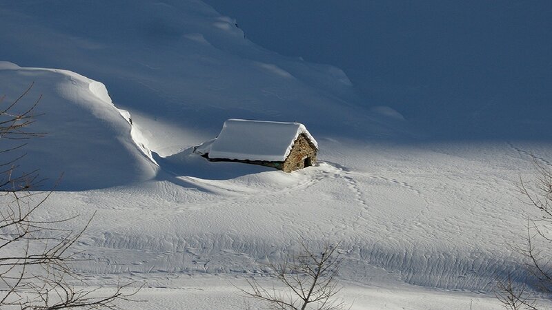 Small Stone Hut in Snow