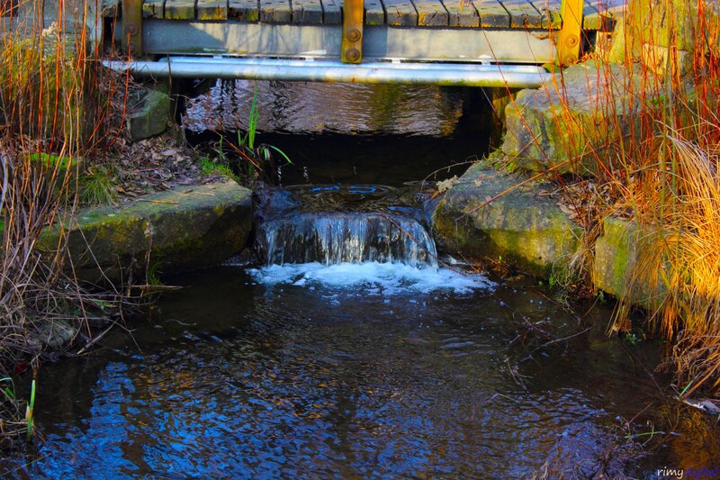 Small waterfall under a bridge