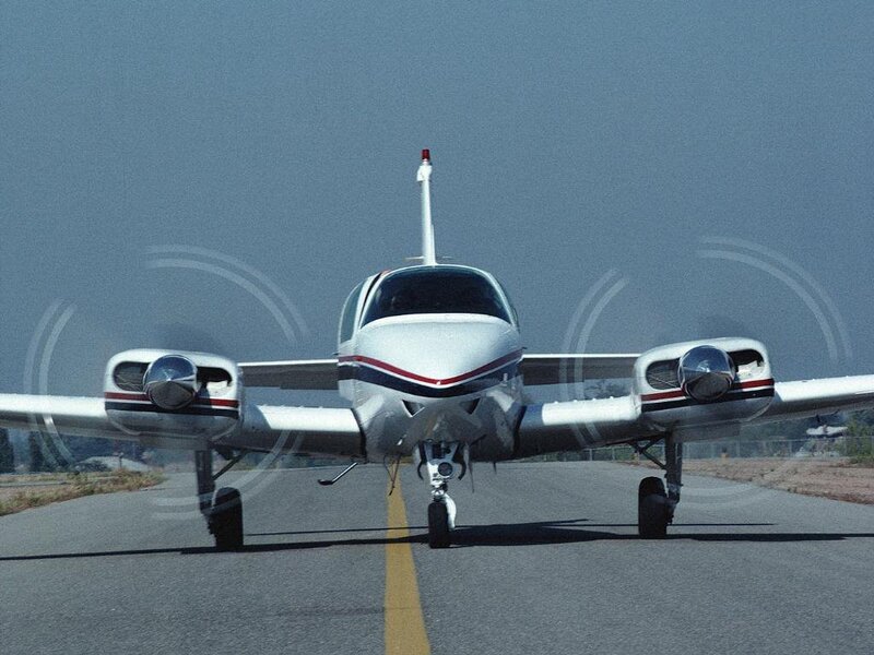 small white airplane on runway