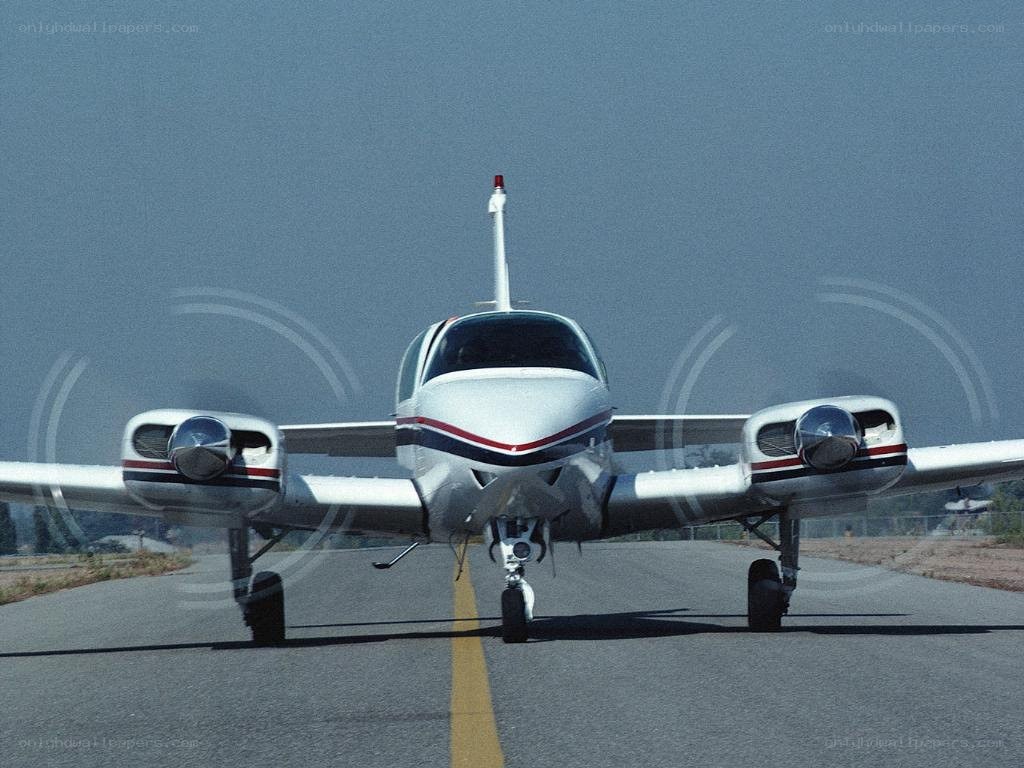small white airplane on runway