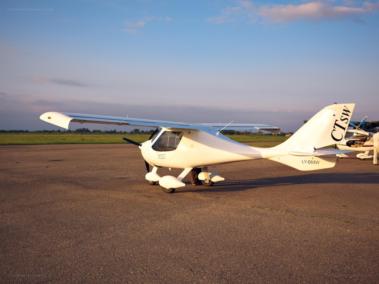 Small white airplane on tarmac