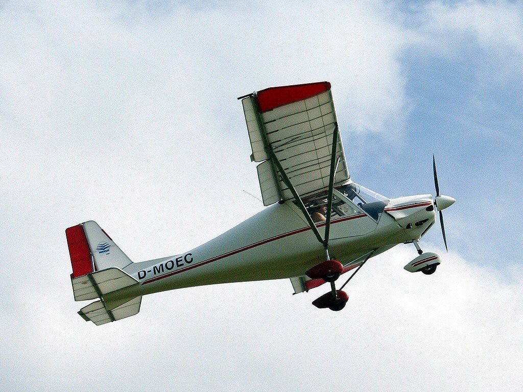 small white and red airplane in flight