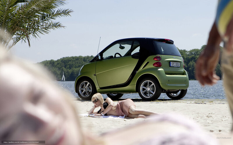 Smart car on beach with woman