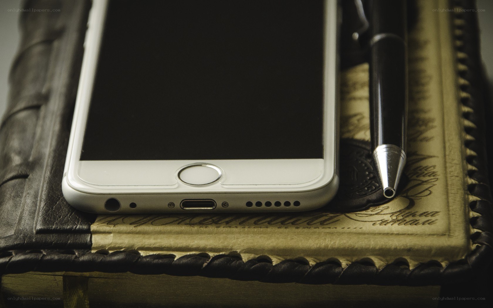 smartphone on book with pen