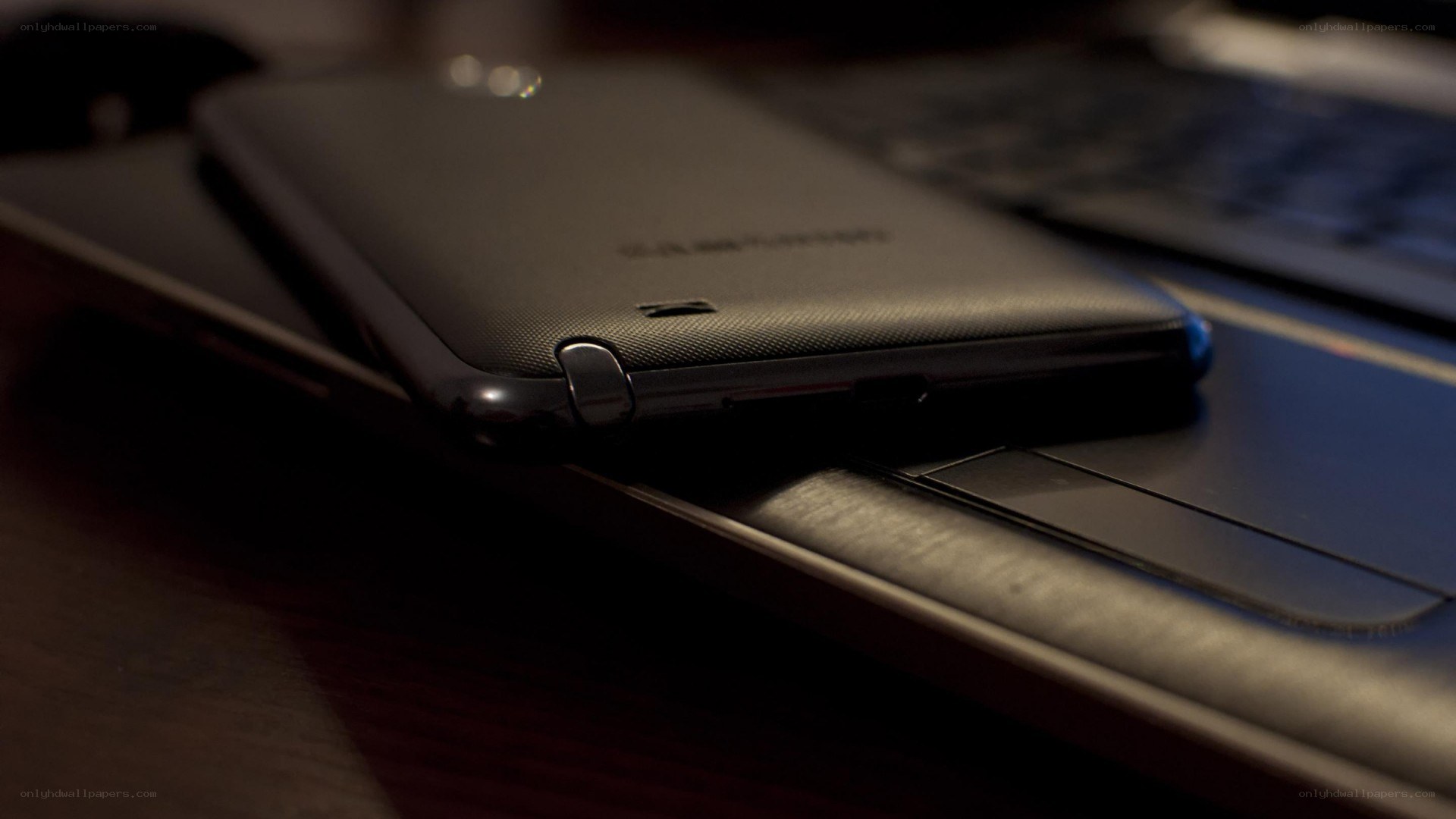 smartphone on laptop keyboard