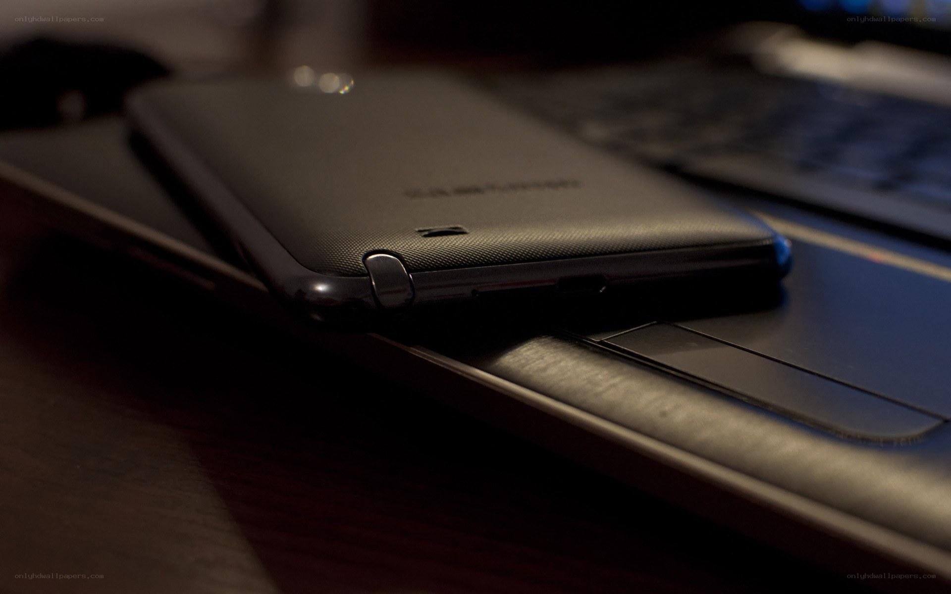 smartphone on laptop keyboard