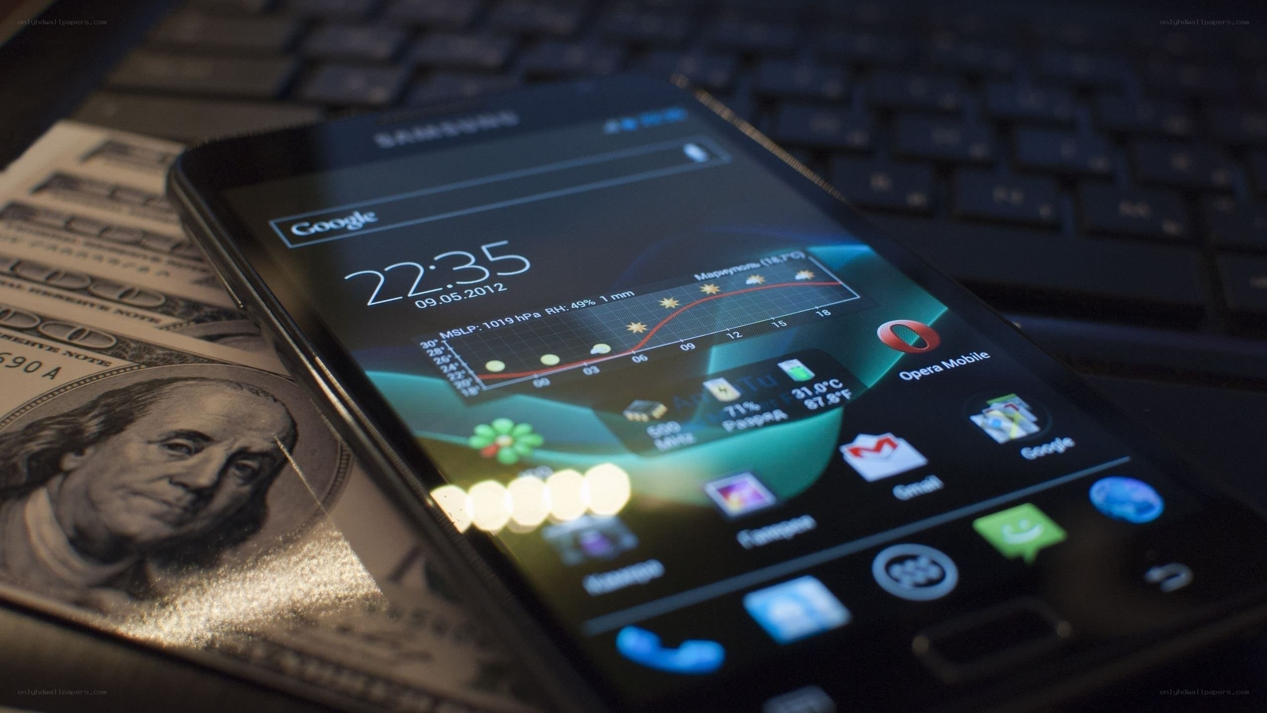smartphone on money and keyboard