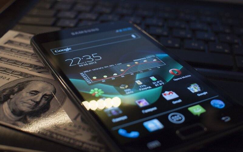 Smartphone on money and keyboard