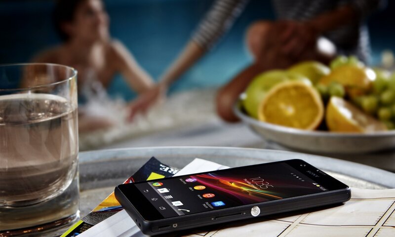 Smartphone on table near pool