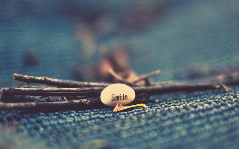 Smile stone on blue fabric