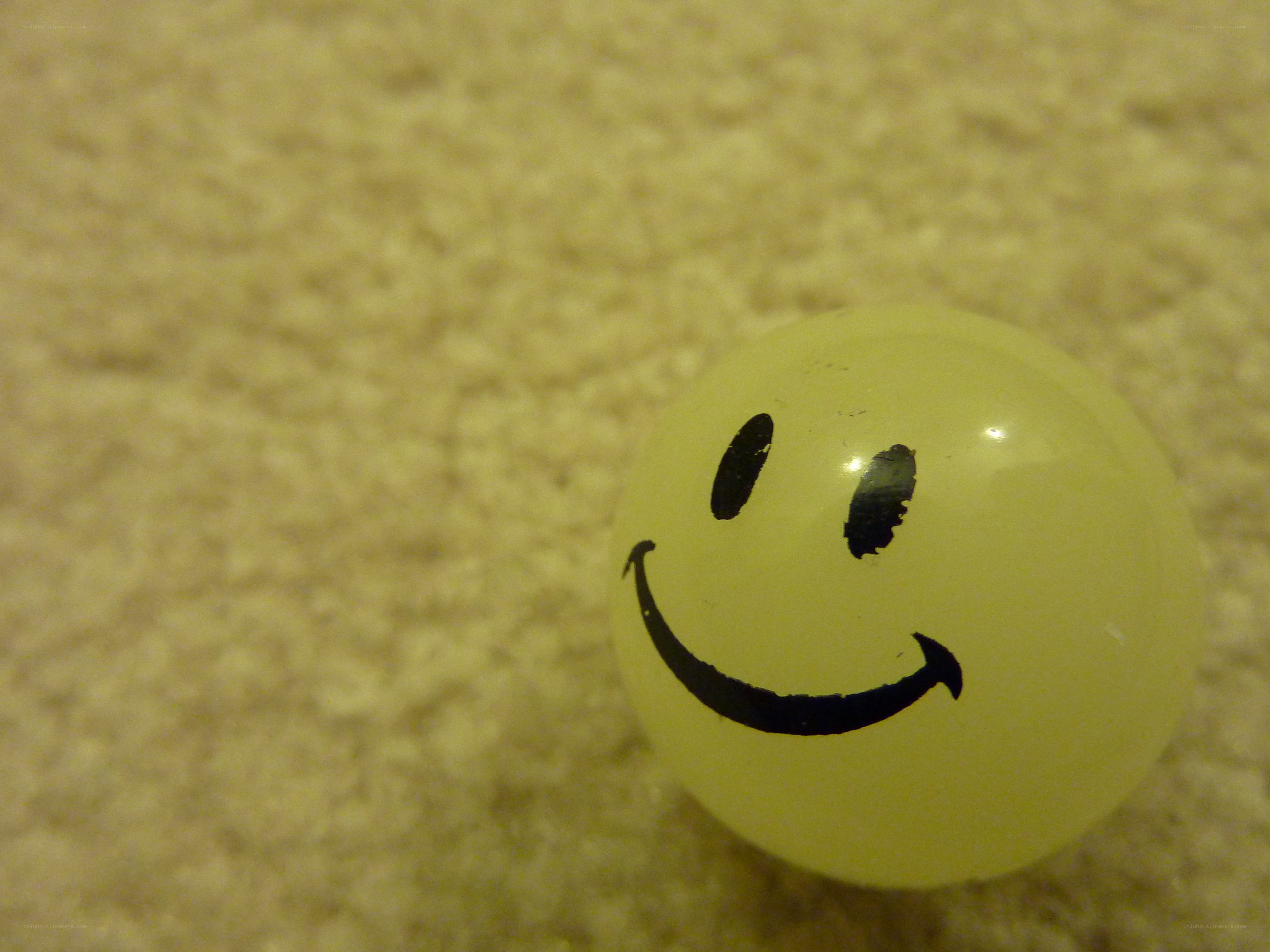 Smiley face ball on carpet