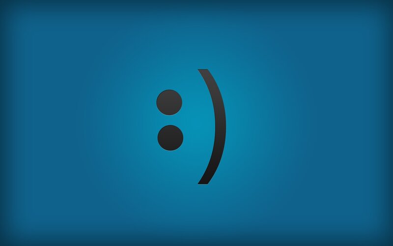 smiley face emoticon on blue
