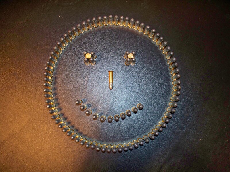 Smiley face made of bullets