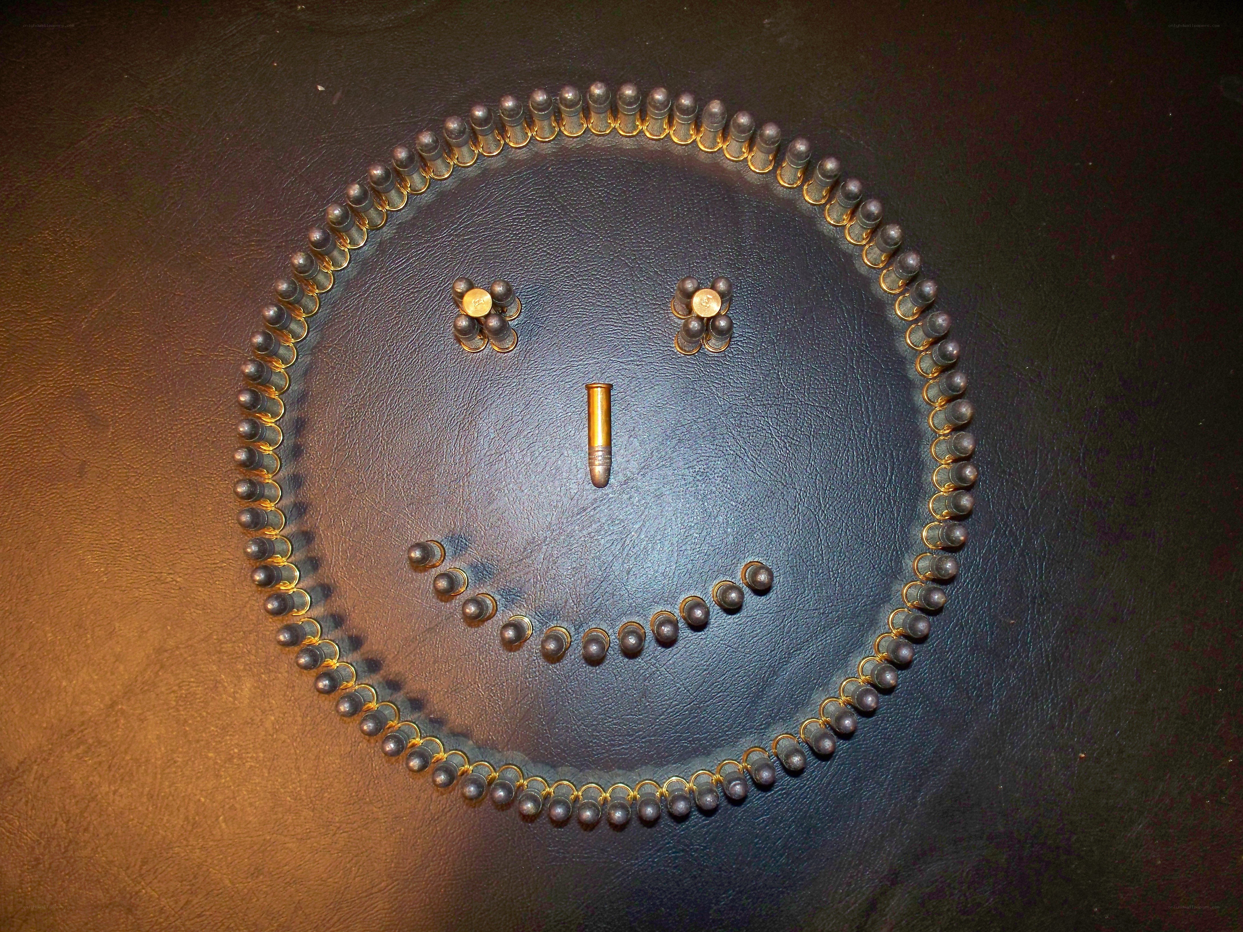 Smiley face made of bullets