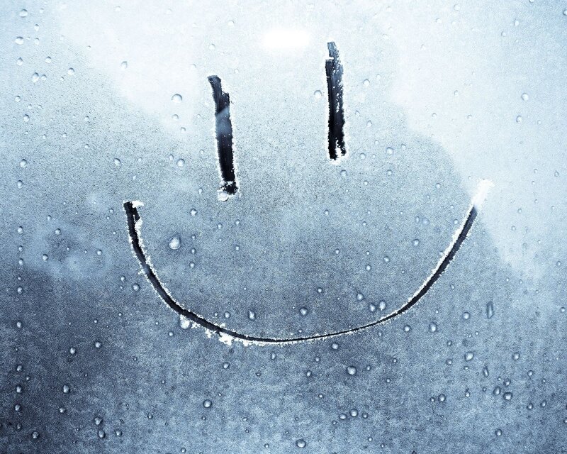 smiley face on fogged glass