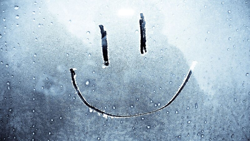 smiley face on fogged glass