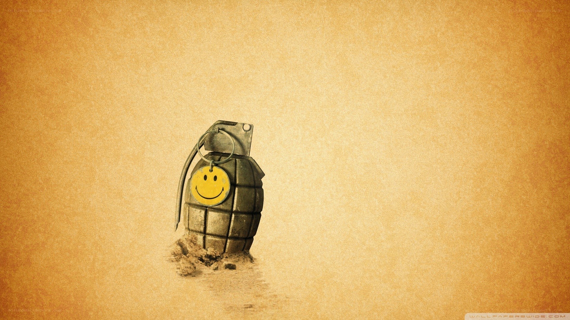 smiley grenade in sand