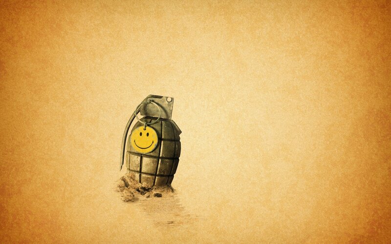 smiley grenade on sand